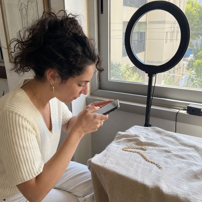 Jewelry seller photographing product