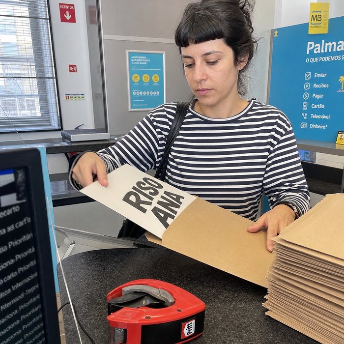 Print shop owner packing posters